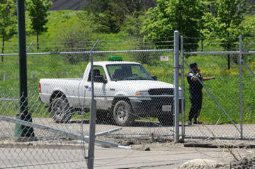 White pickup truck behind a fence
