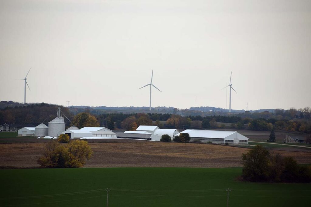 Landscape of a large farm with wind turbines in the distance