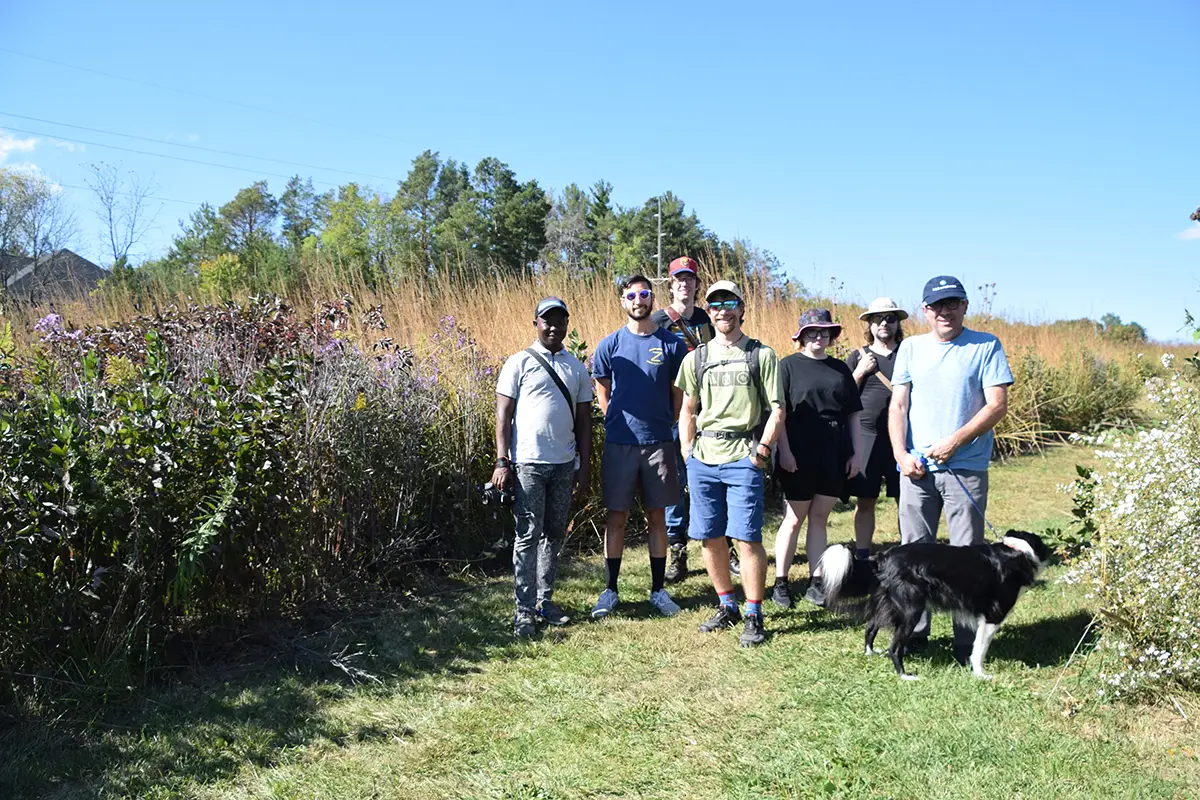 CHE members pose for a group photo on a prairie path