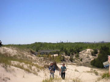 People walking up a sand dune